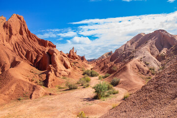 landscape of Skazka canyon on Issyk-Kul lake. Rocks Fairy Tale famous destination in Kyrgyzstan. Mountain like great wall of china and Rainbow Mountains of Danxia or Antelope crevice USA. Central Asia