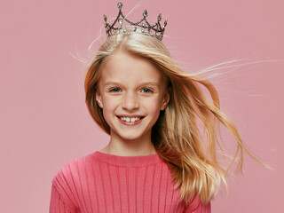Happy and Cute Schoolgirl Wearing a Pink Princess Crown Celebrating at a Birthday Party Description...