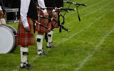 A Scottish pipe band waits on the pitch at the Scottish Highland Games in Crieff