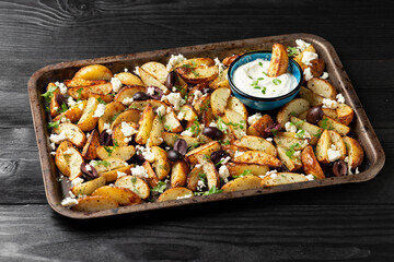 Greek fried potatoes with feta cheese, kalamata olives, parsley and dill