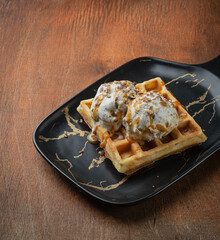 Viennese waffles with ice cream and caramel in vintage royal style