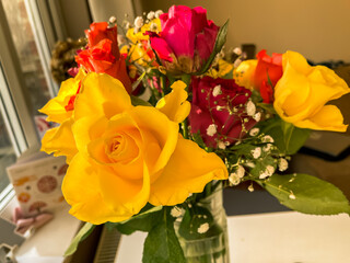 Vase with bouquet of beautiful fresh roses near window, closeup