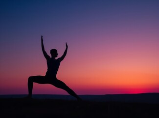 Silhouette of a man in a yoga pose against a sunset background. Beautiful sky.