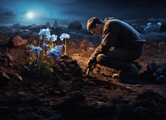 Man kneeling in blue flower field.
