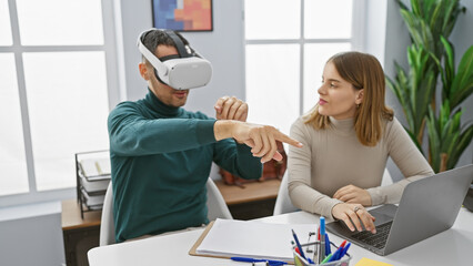 A man wearing a vr headset interacts with a woman co-worker in a modern office setting, symbolizing team collaboration and technological integration in the workplace.