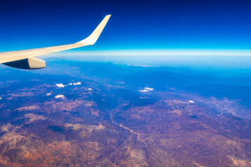 Naklejka na ściany i meble Flying airplane over Mexico Clouds Sky Volcanoes Mountains City desert.