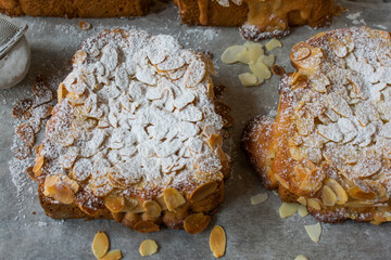 Sweet bread cut into slices and spread with a thin fruit glaze and topped with an almond spread