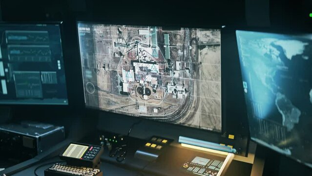 High tech spy system analysing the designated area. High tech spy system controlling a drone flying above the town. High tech spy system identifies the position of the target Chemical Plant.