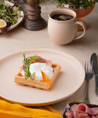 A poached egg cut into a Viennese waffle. Holiday breakfast in vintage style