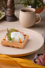 A poached egg cut into a Viennese waffle. Holiday breakfast in vintage style