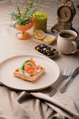 Viennese waffle with salmon and butter cream. holiday breakfast with coffee