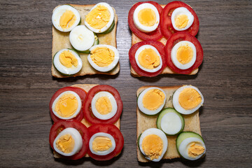 Toasted bread with boiled eggs, tomatoes and cucumber slices 