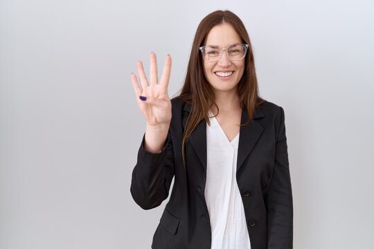 Beautiful brunette woman wearing business jacket and glasses showing and pointing up with fingers number four while smiling confident and happy.