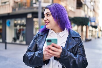 Young beautiful plus size woman smiling confident using smartphone at street