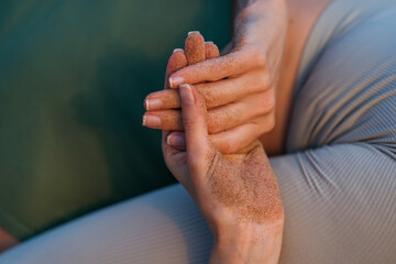 Close-Up of Hands Covered in Sand, Symbolizing Connection with Nature