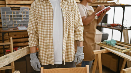 Two carpenters standing together working at carpentry