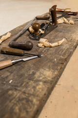 Vertical photo wood carving tools on rustic workbench. Business concept.