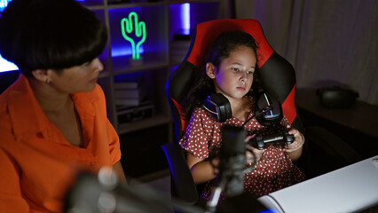 Mother-daughter streamer duo stressed while streaming video game in gaming room, showcasing a...