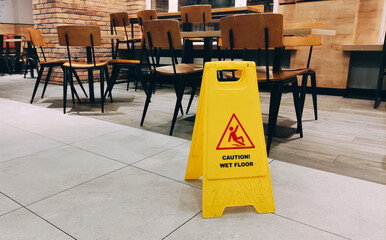 Banner on floor of yellow colour with caution wet floor