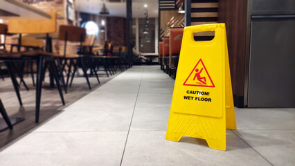 Banner on floor of yellow colour with caution wet floor