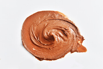 Swirl smear of chocolate cocoa cream on a white background
