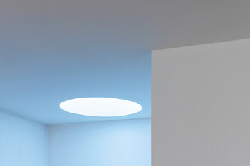 Abstract minimal interior with round blue light portal