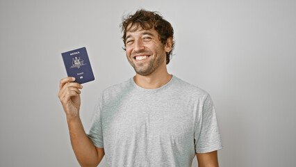 Confident, happy young man joyfully holds his australian passport, smiling against an isolated...