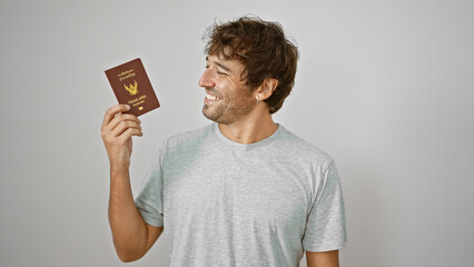Young man smiling holding passport of thailand over isolated white background