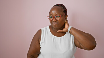 Worried african american woman, overweight and with braids, suffering serious cervical pain,...