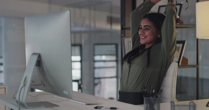 Office, computer and businesswoman for stretching of hands, happy and completed with glasses at night. Person, relax or job satisfaction for project manager, smile or hard work in corporate job