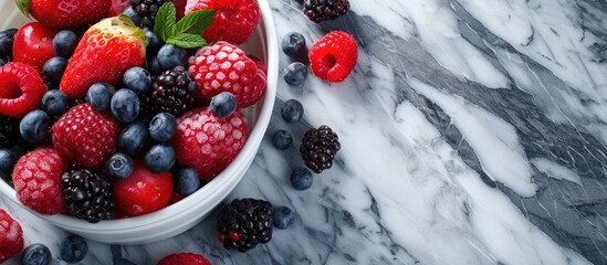 A white bowl overflows with vibrant berries and raspberries against a luxurious marble background....