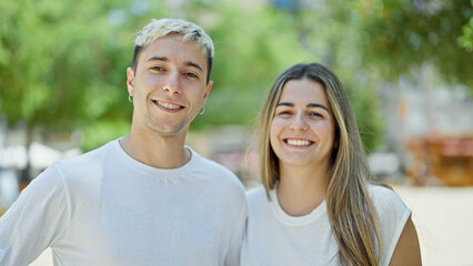 Obraz premium Beautiful couple smiling confident standing together at park