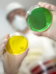 Lab worker with viral petri culture dish