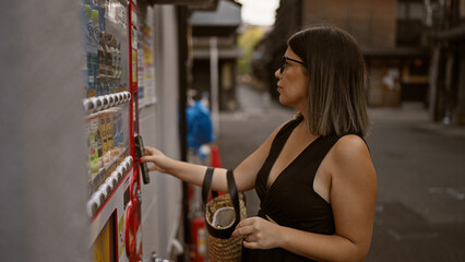 Beautiful hispanic woman with glasses uses phone to buy from kyoto's street vending machine, fusing traditional city charm and modern convenience