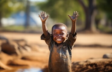 An African-American child gleefully plays with water in a hard-to-reach location in African countries, embodying joy, curiosity, and resilience in the face of challenging access to resources.Generated