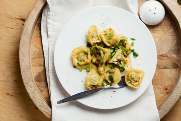 Mushroom tortellini with butter and herbs.