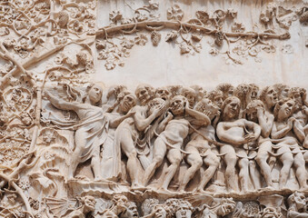 Bas-relief picturing hell, detail on the exterior gable of the cathedral in Orvieto (duomo di Orvieto, cattedrale di Santa Maria Assunta), one of the most beautiful churches in Italy