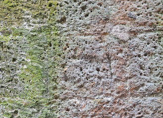 Very old stone wall weathered and affected by water damage, background image