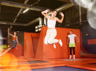 Young woman sportswoman fitness jumping on club trampoline