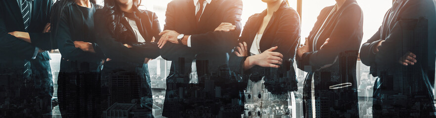Business people group standing together with city office building background double exposure. Modern corporate job and human resources recruiting concept. uds - obrazy, fototapety, plakaty