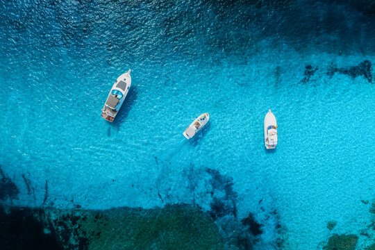 Drone view of a motor boats and yacht. Luxury transportation. Vacationing people. Vacation and holidays. Summer time for sea travel. The sea bay. Photo for background and wallpaper.