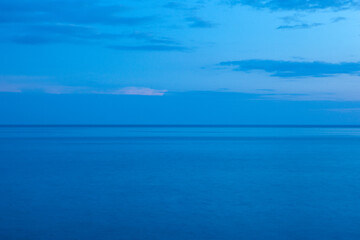 Art blue seascape. A backing with calm sea on sunset for publication, design, poster, calendar,...