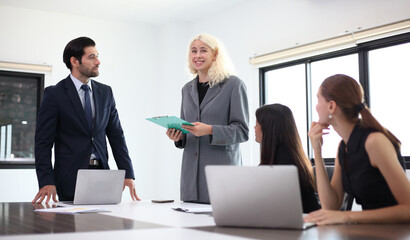 Business People, Successful business professionals. Diverse team celebrating business success at meeting.