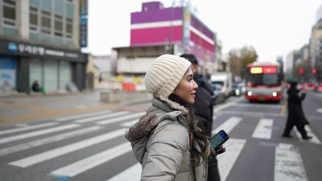 冬の寒い日に大韓民国ソウル市街を散歩する２０代の若いフィリピン人女性のスローモーション映像 Slow-motion video of a young Filipino woman in her 20s walking in Seoul, South Korea on a cold winter day