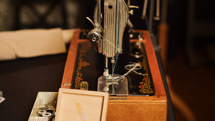 Tools on workstation in fashion atelier, needles and threads used for sewing and manufacturing...