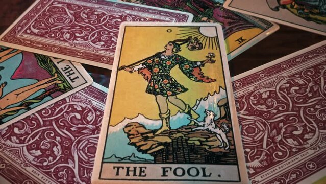 Ljubljana, Slovenia - January 14, 2021. Reading The Fool Tarot Card during a magical ancient forecasting spell. Forecasting future luck in an ancient spell. Forecasting fortune in an ancient spell