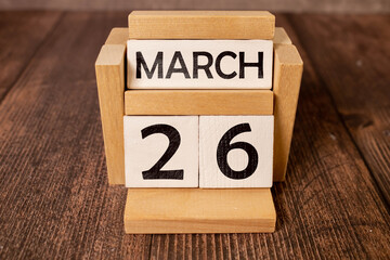 March 26th. Image of march 26 wooden color calendar on blue background. Spring day, empty space for text. - obrazy, fototapety, plakaty