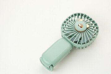 Mini electric fan with handle. Portable electrical equipment 
