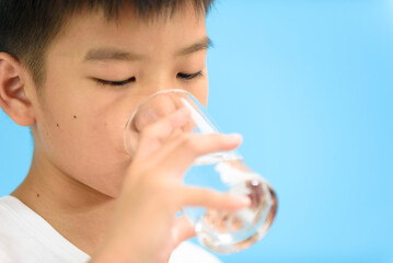 Young Asian boy drink water