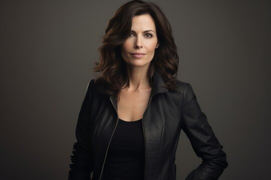 Portrait of a beautiful brunette woman in a black leather jacket